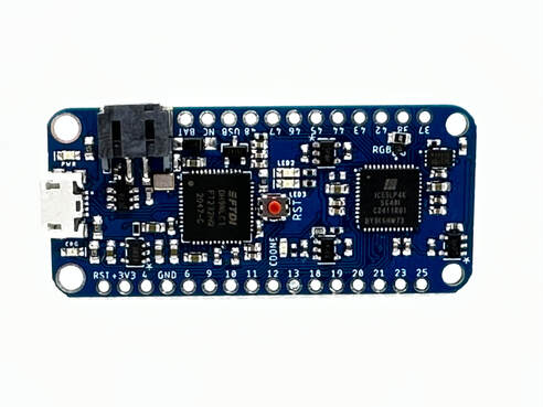 The IcyBlue Feather powered up and connected to USB showing successful programming.